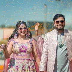 The pure, unadulterated joy of a wedding celebration. This shot captures the vibrant energy of a daytime Mehendi, with flower petals raining down on the happy couple. It’s about capturing the fun, the laughter, and the cool, modern vibe of your celebration.