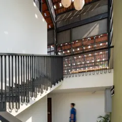The new double-height staircase in the Earthen Spirit building enhances the sense of space and creates a striking play of volumes within the retrofitted structure.