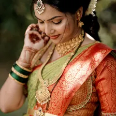A close-up of the expectant mother, showing the details of her traditional gold jewellery. It’s a perfect choice for celebrating this special milestone.