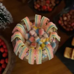 A bowl of colourful rainbow jellies and marshmallows, adding a playful touch to the dessert spread.