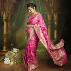 The grace of a mother-to-be in a flowing pink saree. This full-length portrait captures the elegance and beauty of pregnancy, creating a timeless piece of art you'll treasure forever.