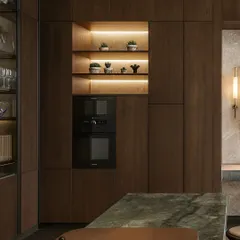 We integrated the oven and microwave into a tall unit, creating a clean, streamlined look. The open shelving with backlighting provides a beautiful display for crockery and adds ambient light.