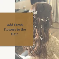 For an effortlessly beautiful festive hairstyle, try adding small clusters of fresh baby's breath. This simple touch adds a delicate and romantic feel to your look.