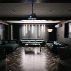 This media room setup combines casual comfort with high-end technology. We integrated a ceiling-mounted projector and a full audio system into a living space, proving you don't need a dark, closed-off room to enjoy cinematic sound and picture quality.