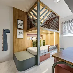 A custom-built bed nook with integrated storage drawers and a unique tree-house-inspired frame. The design creates a cozy and imaginative sleeping area.