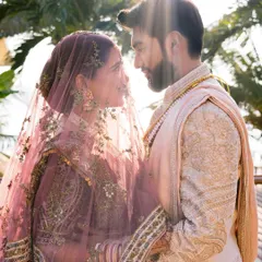 A romantic and sun-kissed moment between the bride and groom. The soft, natural makeup looks beautiful in the golden hour light.