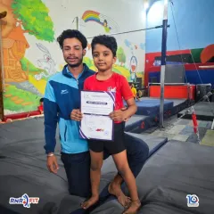 A proud coach with a young champion holding his certificate. These early competitions are crucial for building confidence and a love for the sport.