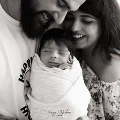 There's a special kind of magic in the first family portrait. This black and white image focuses on the pure joy and connection between new parents and their baby, a timeless memory of when your family grew.