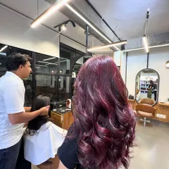A gorgeous magenta hair color, achieved without using bleach. This shows that you can get vibrant results on dark hair with the right professional products.