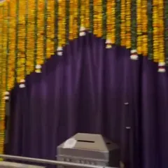 A simple yet beautiful entrance arch made entirely of yellow marigold strings. This is a classic and auspicious choice for any Indian wedding ceremony or home event.