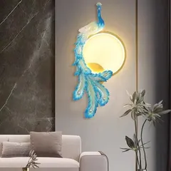 This is a more modern and artistic interpretation of the peacock motif. The stylized form in blue and white wraps around a circular light source, creating a striking piece of wall art that illuminates from within.