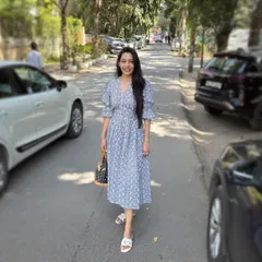 This client is wearing an easy, breezy, and chic Schiffli summer dress in a lovely blue and white print. With its comfortable fit and puff sleeves, it's the perfect go-to dress for a sunny day.