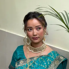 A different angle of the elegant bridal look, highlighting the glowing skin and perfectly blended eyeshadow.