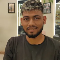 A happy male client showing off his new textured haircut with blonde highlights. This look is modern, edgy, and full of personality.