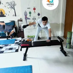 A client performs a single-arm dumbbell row using a bench for support. This is an excellent exercise for building a strong back, improving posture, and correcting muscle imbalances.