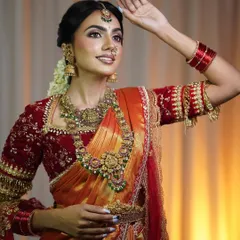 The perfect pose to showcase the complete bridal ensemble. This orange and red silk saree is a favorite in my collection for its vibrant, celebratory feel.