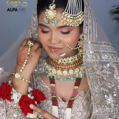 A beautiful portrait of a Valima bride, holding roses. The makeup is soft and romantic, with a focus on glowing skin and subtly defined eyes.