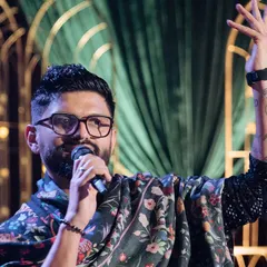 A close-up shot of me on stage, completely in my element, hosting a beautiful wedding celebration. The energy of the crowd and the happiness of the family is what I live for.