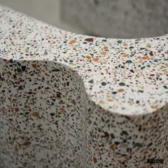 The wavy, sculptural form of the terrazzo bookshelf allows it to be both a functional storage unit and a captivating art piece, demonstrating how we can turn everyday objects into something extraordinary.