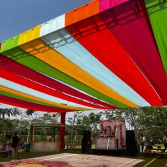 The main party area for the 'Hues of Flavour' Holi event, with a custom dance floor and colorful overhead decor.
