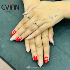 From another angle, you can appreciate the 3D gold bands on the red nails. This kind of detailed work on gel extensions ensures your manicure is a true piece of art.