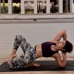 A deep side-body stretch that releases tension and prepares the body for the week ahead. This pose targets the obliques and hips, creating a sense of mindful release and balance.