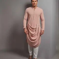 A modern twist on a classic silhouette, this draped pink kurta from The House of Govinda is for the man who isn't afraid of color or contemporary design. It's a statement piece that is both stylish and comfortable.