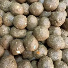 A close-up of our nutritious and delicious Methi Gond Laddoos. These winter superfood treats are packed with fenugreek, edible gum, pure ghee, and dry fruits, perfect for boosting immunity.