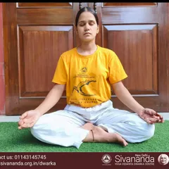 A student sits in Sukhasana (Easy Pose) for meditation. Daily meditation is a key practice for achieving emotional balance and inner peace.