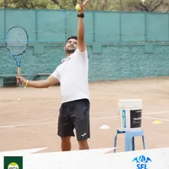 A coach demonstrates the proper serving motion. Our certified coaches lead by example, providing clear, hands-on instruction to help players master every part of the game.