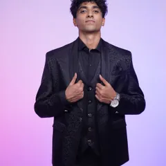 A classic black tuxedo that always gets it right. The patterned jacket and sharp tailoring make this a timeless choice for any black-tie event.