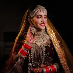 That priceless smile of a happy bride. This candid shot captures the bride's joy on her wedding day, with beautiful lighting that accentuates her smile and the sparkle of her jewelry.