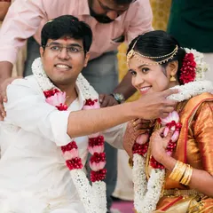 A beautiful moment from a South Indian wedding ceremony, where the couple exchanges garlands, symbolizing their union.
