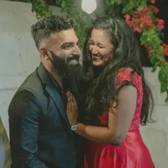 A candid shot of a couple sharing a genuine laugh during their romantic evening pre-wedding shoot.
