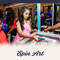 The magic of spin art! A young guest adds paint to a spinning canvas to create a unique, colorful masterpiece. It's a mesmerizing and fun process for all ages.