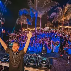 This is the view from my console in Mauritius, a sea of energy under the palm trees. It's moments like these, connecting with thousands of fans and feeling the collective joy, that define my performances at large-scale concerts and festivals.