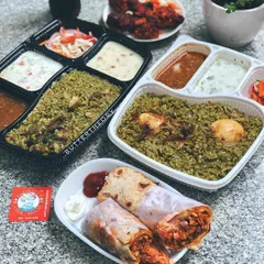 I love seeing how food bloggers plate my dishes. This shot perfectly captures a meal for two, with our rolls, biryani, and sides all ready to be enjoyed. It’s a great example of a complete meal order.