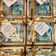 A top-down view of the baby announcement hampers, all packed and ready to go. The consistent theme and beautiful packaging make for a stunning collective presentation.