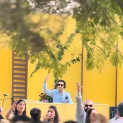 When life gives you a bright yellow backdrop, you play the zestiest tunes. A fun shot from a sunny mehndi party where the playlist was as vibrant as the decor.