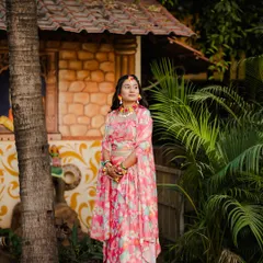 A beautiful outdoor shot of a client ready for her Haldi or Mehendi. The floral outfit is paired with matching floral jewelry and fresh, natural makeup.