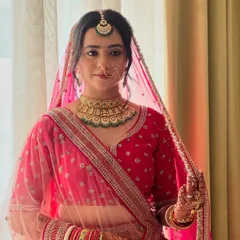 A candid moment of my bride Neha, looking serene and beautiful in her pink Phera look. The soft pink eyeshadow and matching lip tint create a harmonious and romantic bridal style.