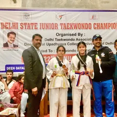 Celebrating victory at the Delhi State Junior Taekwondo Championship. I am proud to stand with my gold medalists, Khushi and Priya, who both earned their spot in the National Championship.
