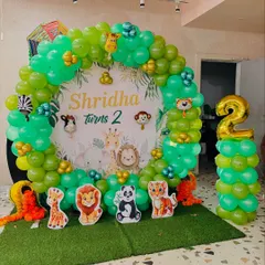 For a kid's second birthday, I created this fun jungle theme. The setup includes a custom backdrop with cartoon animals, a circular balloon arch in shades of green, and animal cutouts to bring the safari party to life.
