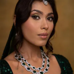 A close-up showcasing the detailed eye makeup with a pop of gold. The soft contouring and luminous skin finish give the face a sculpted yet natural dimension.