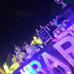 A wide-angle view of the bustling LED bar at night. This perspective shows how the bright, colorful lighting makes the bar a central attraction, drawing guests in and energizing the party atmosphere.