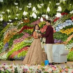 For this reception, I created a breathtaking wall of fresh, multi-colored flowers. This kind of large-scale floral art makes for an unforgettable backdrop and stunning photographs.