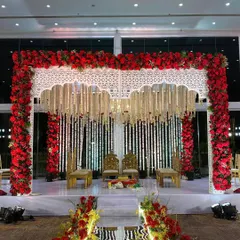 We believe in the timeless power of tradition. This magnificent mandap, framed by a rich arch of red roses and adorned with delicate white floral strings, creates a sacred and visually stunning space for wedding vows.