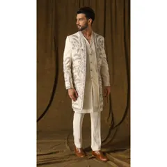 This ivory shrug set is an example of my luxury fusion wear. The open jacket, adorned with cream and gold garden-inspired embroidery, is layered over a handwoven geometric-patterned kurta for a look that is both artistic and sophisticated.