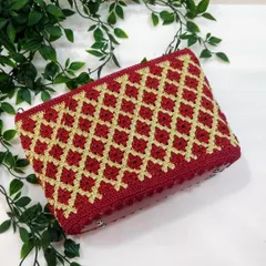 My signature diamond pattern clutch in a festive maroon and gold. This piece is a favourite for pairing with ethnic wear, and I take great care in getting every stitch just right. It's a timeless design that I love to create.