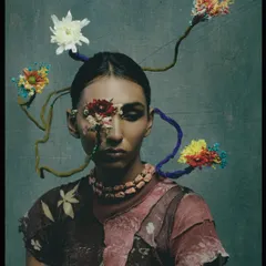 A look from the "Concrete Woes" series, which explores our relationship with nature. This avant-garde makeup uses floral elements to create a piece of living art.